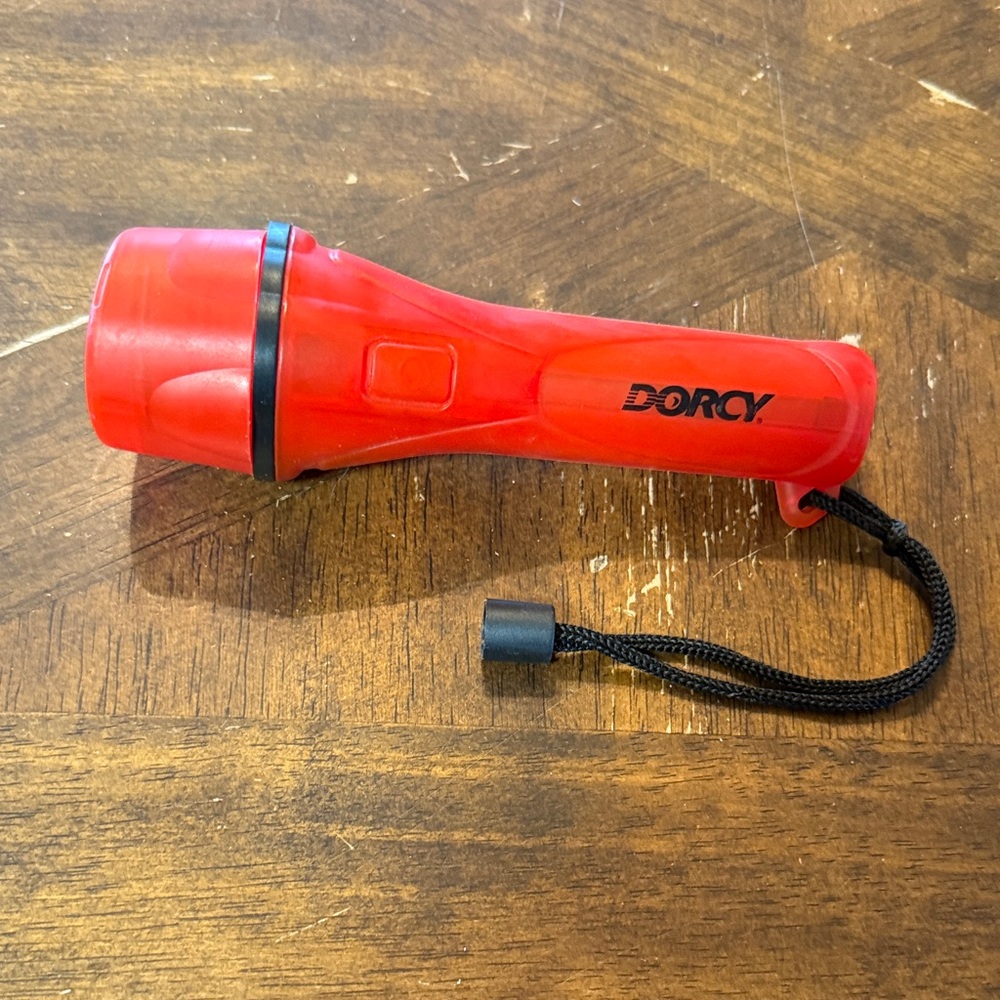 Dorcy Red Handheld Flashlight in good used condition